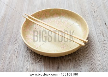 One Yellow Green Plate With Chopsticks On Gray