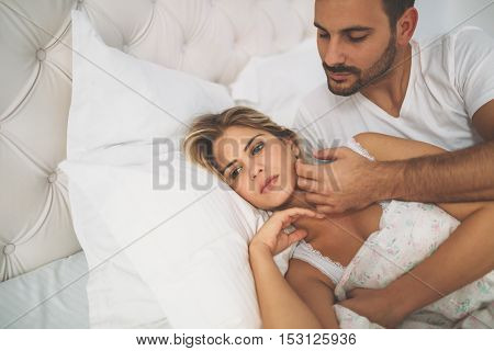 Relationship crisis in bed with feeling of guilt