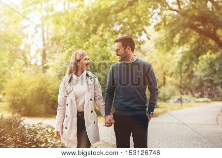 Happy couple in love walkin in park
