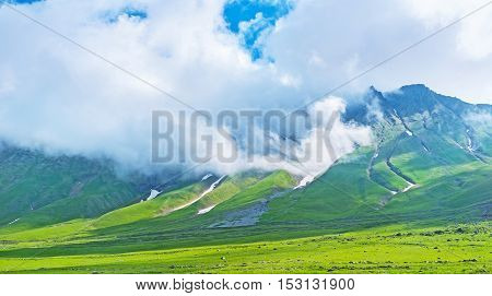 The mountain at the Cross Pass covered with hard cloud formation Gudauri Georgia.