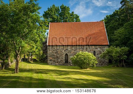 Lovoy medieval chapel and famous spring's water source, believed to have healing power. Falkensten, Norway.
