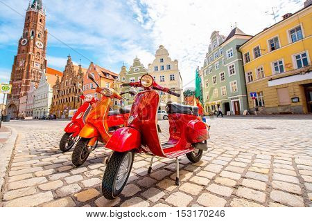 Landshut, Germany - July 04, 2016: Retro red Vespa scooters on the street in Landshut old town in Germany.
