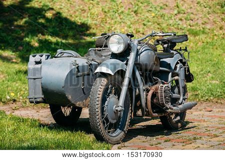 The Old Rarity Tricar, Three-Wheeled Gray Motorcycle With A Sidecar Of German Forces Of World War 2 Time Standing As An Exhibit In Summer Sunny Park.