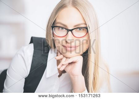 Portrait of gorgeous smiling caucasian businesswoman in eyeglasses and formal outfit