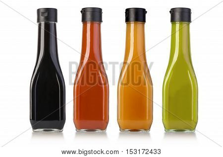 various barbecue sauces in glass bottles on white backgroubd