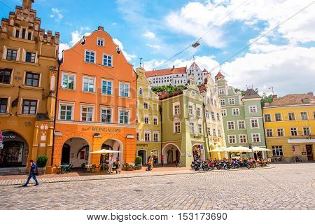 Landshut, Germany - July 04, 2016: Crowded street with colorful houses in the center of Landshut old town, Germany