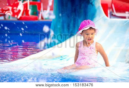 outdoor portrait of young smiling child having fun in aquapark