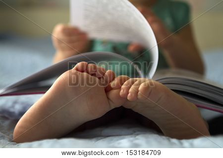 Foot closeup.An image of a toddler reading a book.