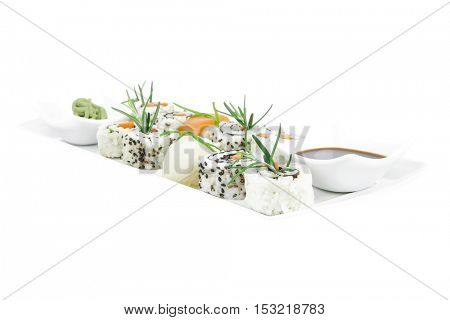 California Roll with Avocado and Salmon, Cream Cheese and Raw Salmon inside. on long white plate . isolated over white background . Maki Sushi and Sashimi