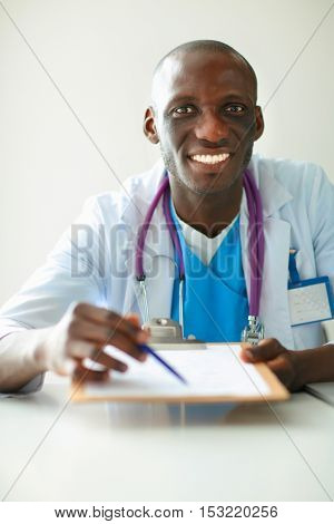 Male doctor sitting at his desk