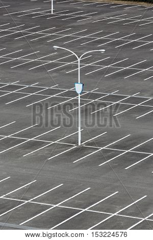 vacant car parking lot with white mark and light pole