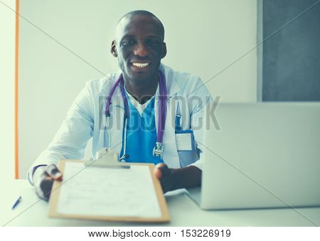 Male doctor sitting at his desk