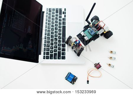UKRAINE, KHARKIV- OCTOBER 1 , 2016. Diy rc car made on base Arduino Pro Micro microcontroller and construction Lego Technic on laptop. Electronic components on geek workplace