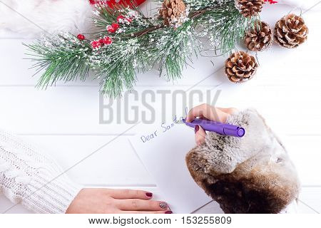 woman hands writing on christmas postcard closeup hands