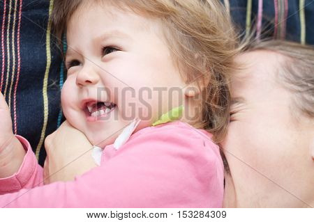 Happy child and daddy having fun laughting very emotional