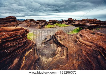 Sandy rocks with by magma formed by winds. Popular tourist attraction. Unusual and gorgeous scene. Location Sudurland, cape Dyrholaey, south coast of Iceland, Europe. Artistic picture. Beauty world.