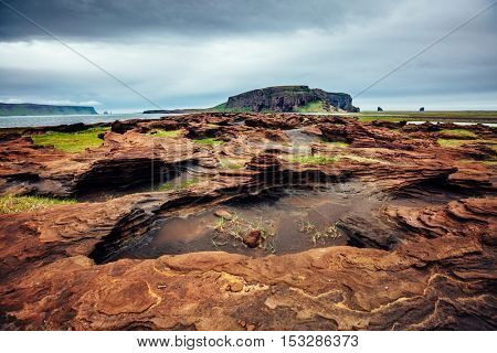 Sandy rocks with by magma formed by winds. Popular tourist attraction. Unusual and gorgeous scene. Location Sudurland, cape Dyrholaey, south coast of Iceland, Europe. Artistic picture. Beauty world.