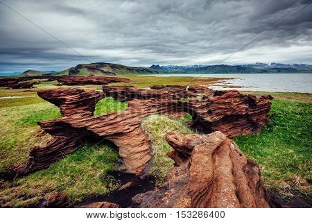 Sandy rocks with by magma formed by winds. Popular tourist attraction. Unusual and gorgeous scene. Location Sudurland, cape Dyrholaey, south coast of Iceland, Europe. Artistic picture. Beauty world.