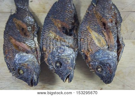 Three fish body fry on Chopping Wood and asian food.