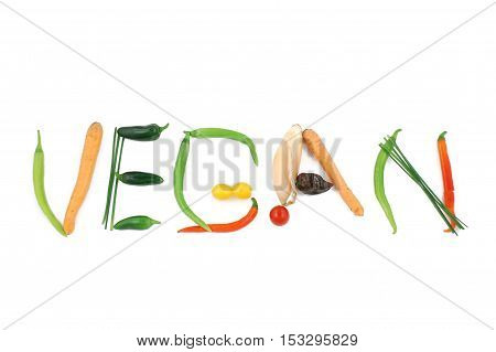 Word vegan written with vegetables, as a metaphor or concept for healthy food, living, diet, recipe. Isolated on white background