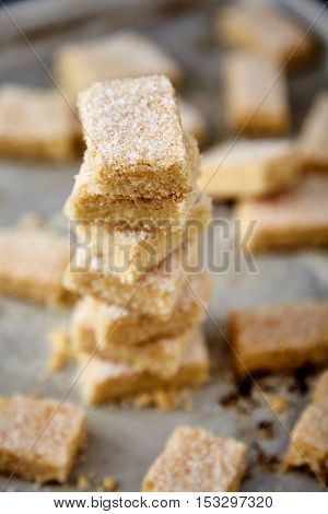 Delicious homemade sugar cookies made from semolina, butter, flour and sugar. Crumbly, delicate texture, the sugar crust on top. A little sweetness to the tea on gray background. Selective focus