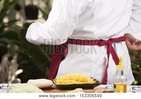 Chef dress up and tied aporn before cooking