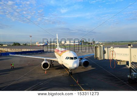 Moscow, Russia - May 27, 2016: Iberia airlines aircraft prepares for boarding passengers through a telescopic ladder at the Domodedovo airport in Moscow, early morning