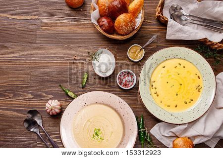 Dinner table. Various soups on the table top view. Ukrainian and Russian national fish soup and mushroom soup. Food background with copy space.