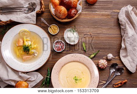 Assorted soups on the table overhead view. Ukrainian and Russian National fish soup. Mushroom soup. Food background with copy space.
