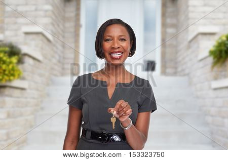 African-American realtor woman with key.