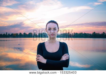 Young Woman Portrait In Early Morning At Colorful Sunrise Background