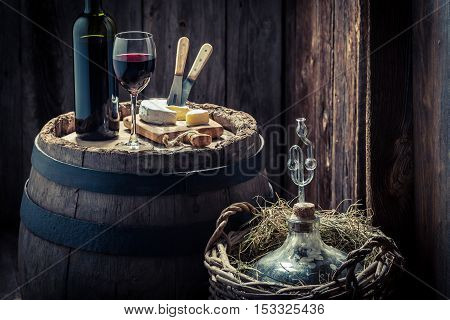 Tasty Red Wine With Camembert Cheese And Demijohn
