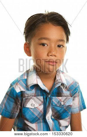Cute Filipino Boy on a White Background.  He is looking at the camera with a blank, sad or serious expression