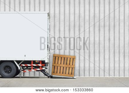 transportation and vehicle concept - Delivery truck parking to delivery parcel wood box with wood wall and copyspace