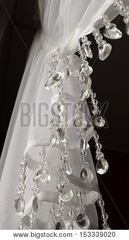 Closeup on the part of the white curtainsider with dangling crystals