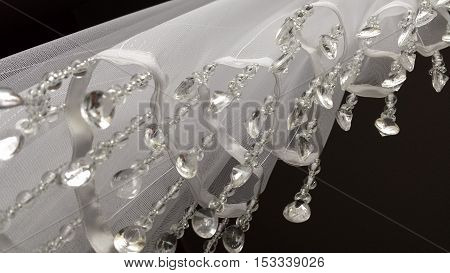 Closeup on the part of the white curtainsider with dangling crystals