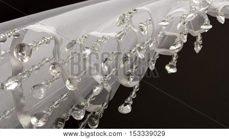 Closeup on the part of the white curtainsider with dangling crystals