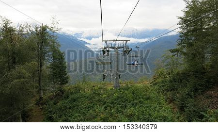 People ride on the cableway in the mountains