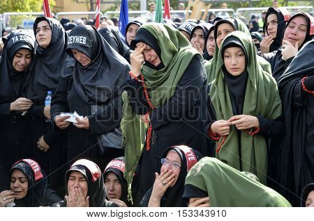 Istanbul Turkey - October 11 2016: Shia Muslim women mourn during an Ashura. Turkish Shia Muslims mourning for Imam Hussain. Caferis take part in a mourning procession marking the day of Ashura in Istanbul's Kucukcekmece district Turkey on October 11 2016