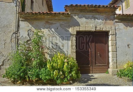 An old wooden door in Valvasone in Friuli Venezia Giulia north east Italy.
