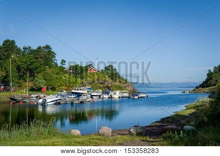 Typical nordic bay with recreational boats moored. Falkensten, Norway.