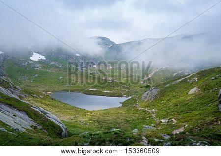Small mountain lake on the hiking route to Kjeragbolten stone. Norway nature landscape.