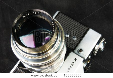 DONETSK, UKRAINE - May 07, 2016: old soviet film SLR camera Zenit - B with lens Jupiter-11, for use with 35 mm film, made in USSR in 1968 - 1973, manufactured by KMZ, with original leather case