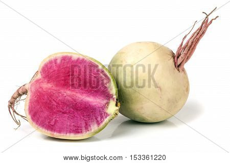 One whole and sliced watermelon radish isolated on white background.