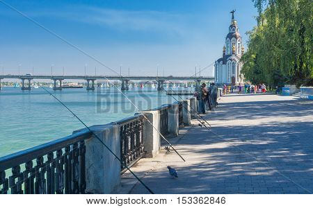 DNEPR UKRAINE - SEPTEMBER 10 2016:Dnepr river embankment with fishermen and their rods during City Day local activity in Dnepr, Ukraine at September 10, 2016