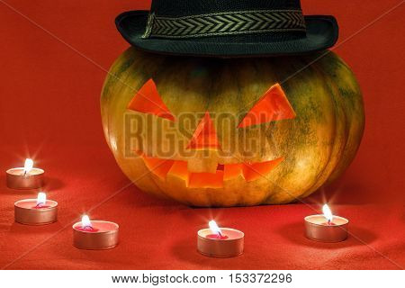 Pumpkin for Halloween with glowing eyes by candlelight