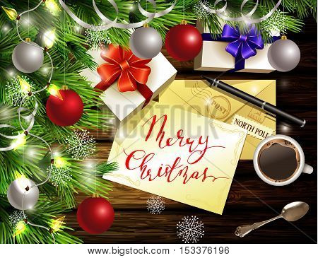Christmas New Year design light wooden background with christmas tree and silver and red balls and wish list coffee teaspoon gift boxes envelope for santa and pen and handwritten Merry Christmas.