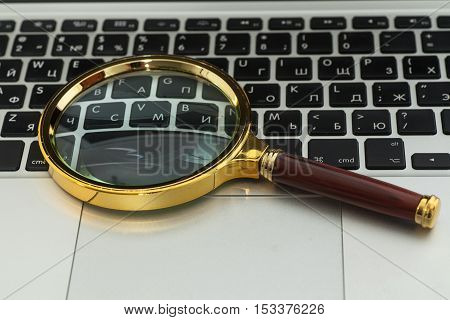 Laptop Computer With Magnifying Glass close up