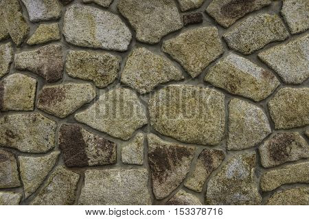 The wall compiled from large colored stones