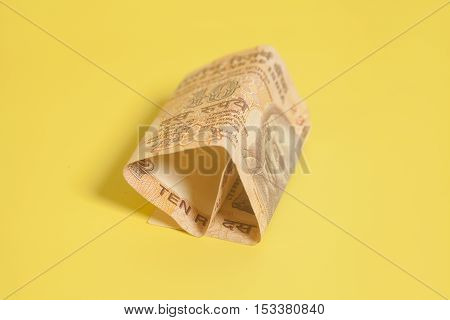 Ten rupee note (Indian Currency) on yellow background